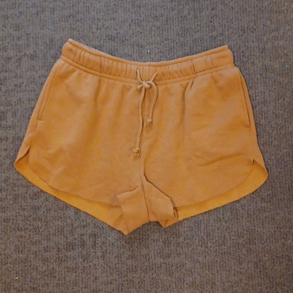 Sweat shorts, high thigh, mustard brown. Worn lightly